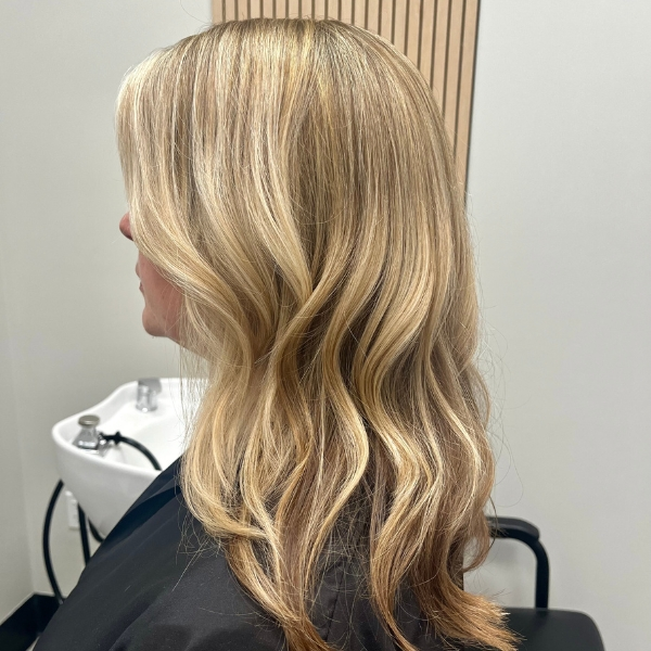 Blonde highlights with soft waves after a fresh haircut at MZ Hair Studio in Bridgewater, NJ, styled for a natural, sun-kissed look.