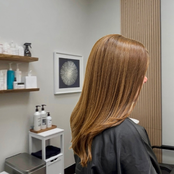 Smooth brunette hair color with a sleek blowout at MZ Hair Studio in Bridgewater, NJ, styled for shine and healthy movement.